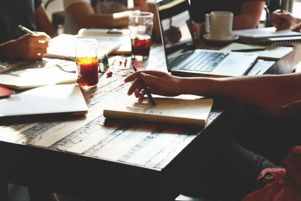 Werktafel met koffie, laptop en aantekeningen